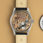 Omega Jumbo 2639-12 opened, movement visible from the caseback side, vintage watch