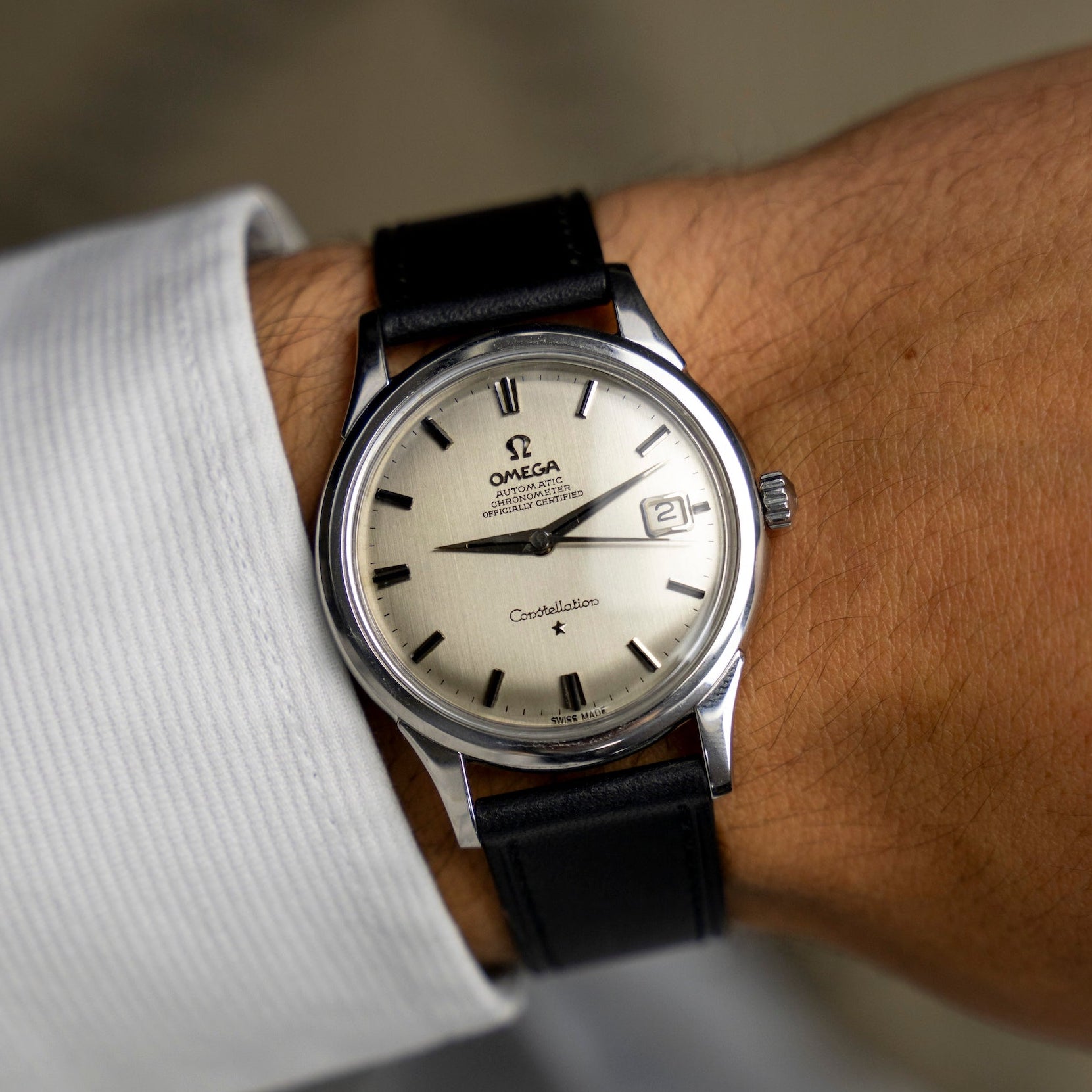Montre vintage Omega Constellation 168.001 de 1963 au poignet, cadran argenté et date à 3 heures