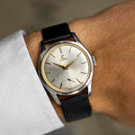 Vintage Omega Jumbo 2639-12 from 1952 on the wrist, silver sunburst dial and black leather strap