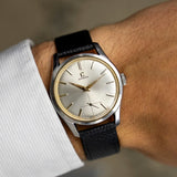 Vintage Omega Jumbo 2639-12 from 1952 on the wrist, silver sunburst dial and black leather strap