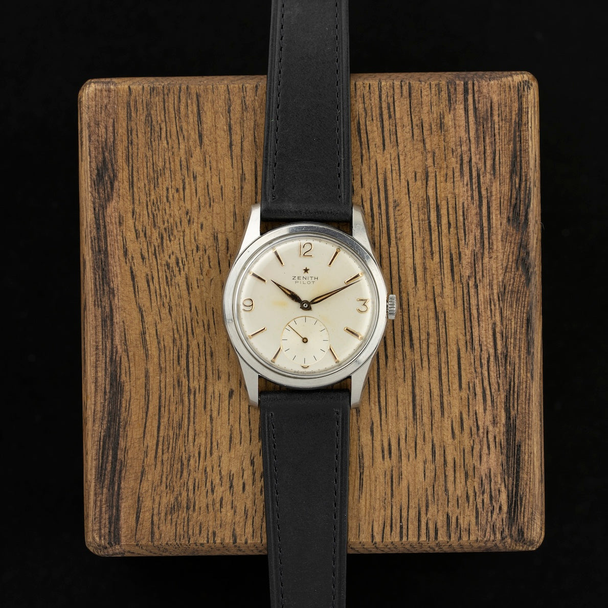Vintage Zenith Pilot front view, resting on a wooden stand